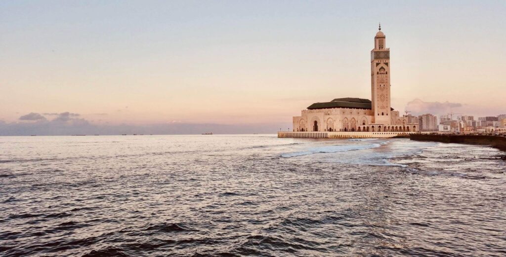 Your Ultimate Morocco Adventures : Top Tailor-Made Tours for 2025 6 Majestic view of the Hassan II Mosque in Casablanca, Morocco, with its towering minaret and intricate architectural details