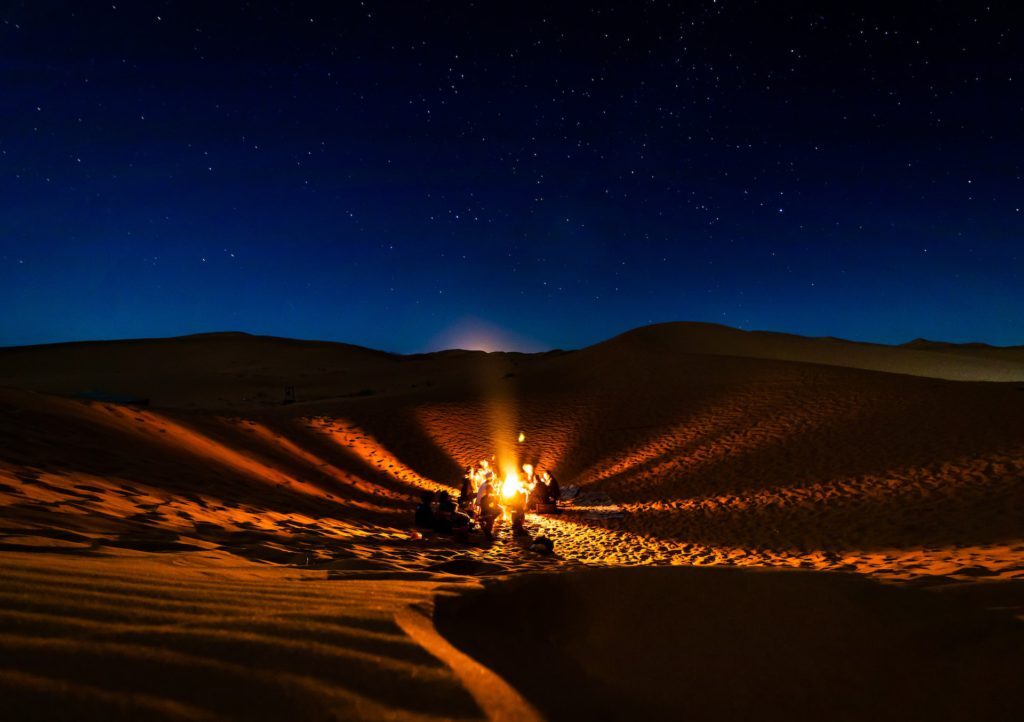 Rejuvenating Peaceful desert spa setting with yoga mats, natural treatments, and serene sand dunes in the background