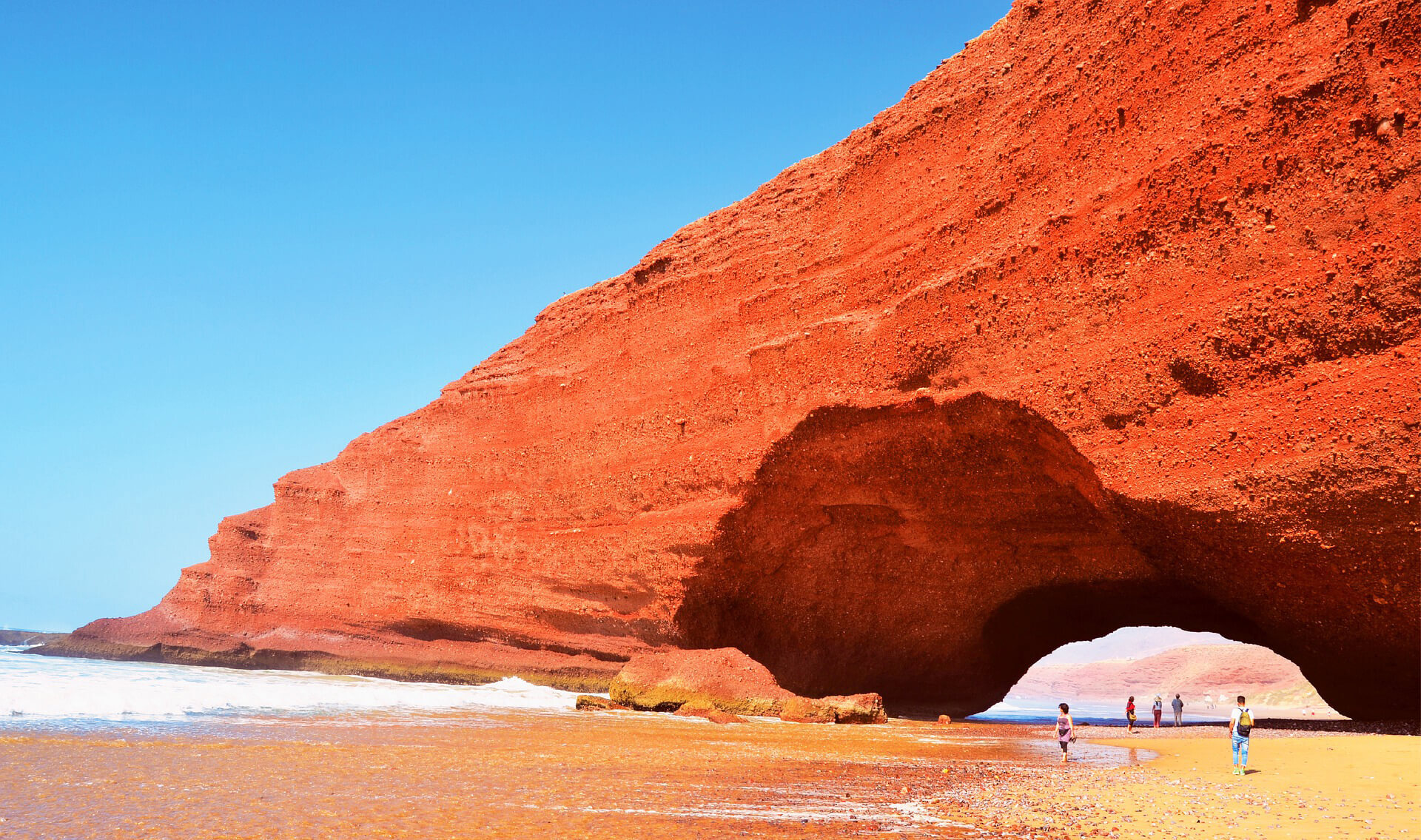 Scenic view of a remote coastal village in Southern Morocco, with traditional houses and rugged coastline