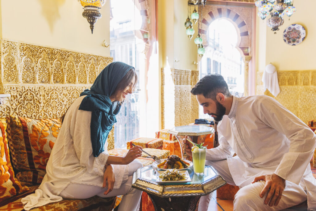 Romantic Moroccan kitchen setting with cooking activities that foster love and connection, featuring a cozy atmosphere and traditional dishes.