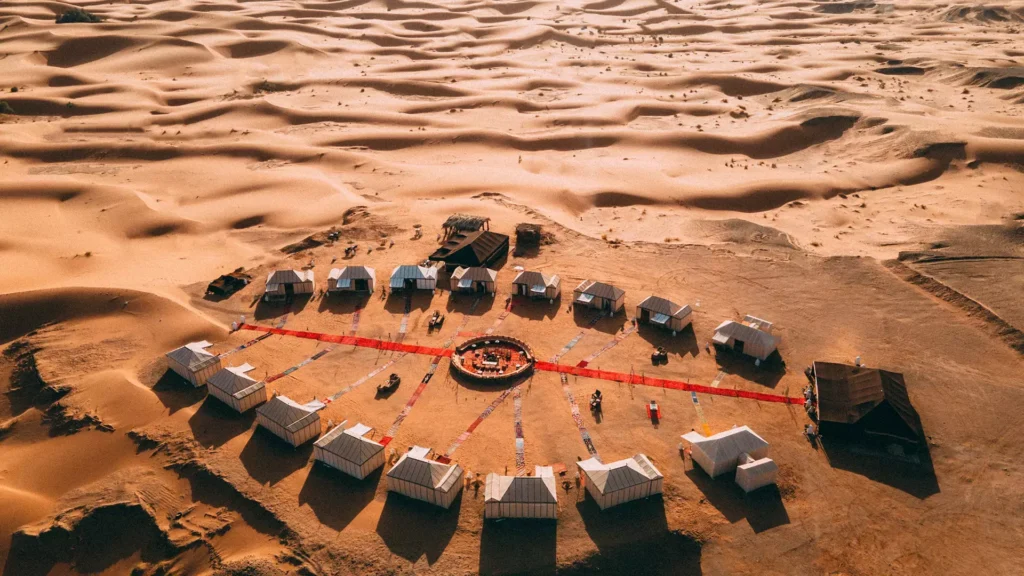 Morocco Excursions 2025: Unlock Exclusive Experiences with Insider Deals on Tickets and Tours 7 Luxurious desert oasis retreat in Erg Chebbi, Sahara Desert, featuring sustainable accommodations surrounded by golden dunes