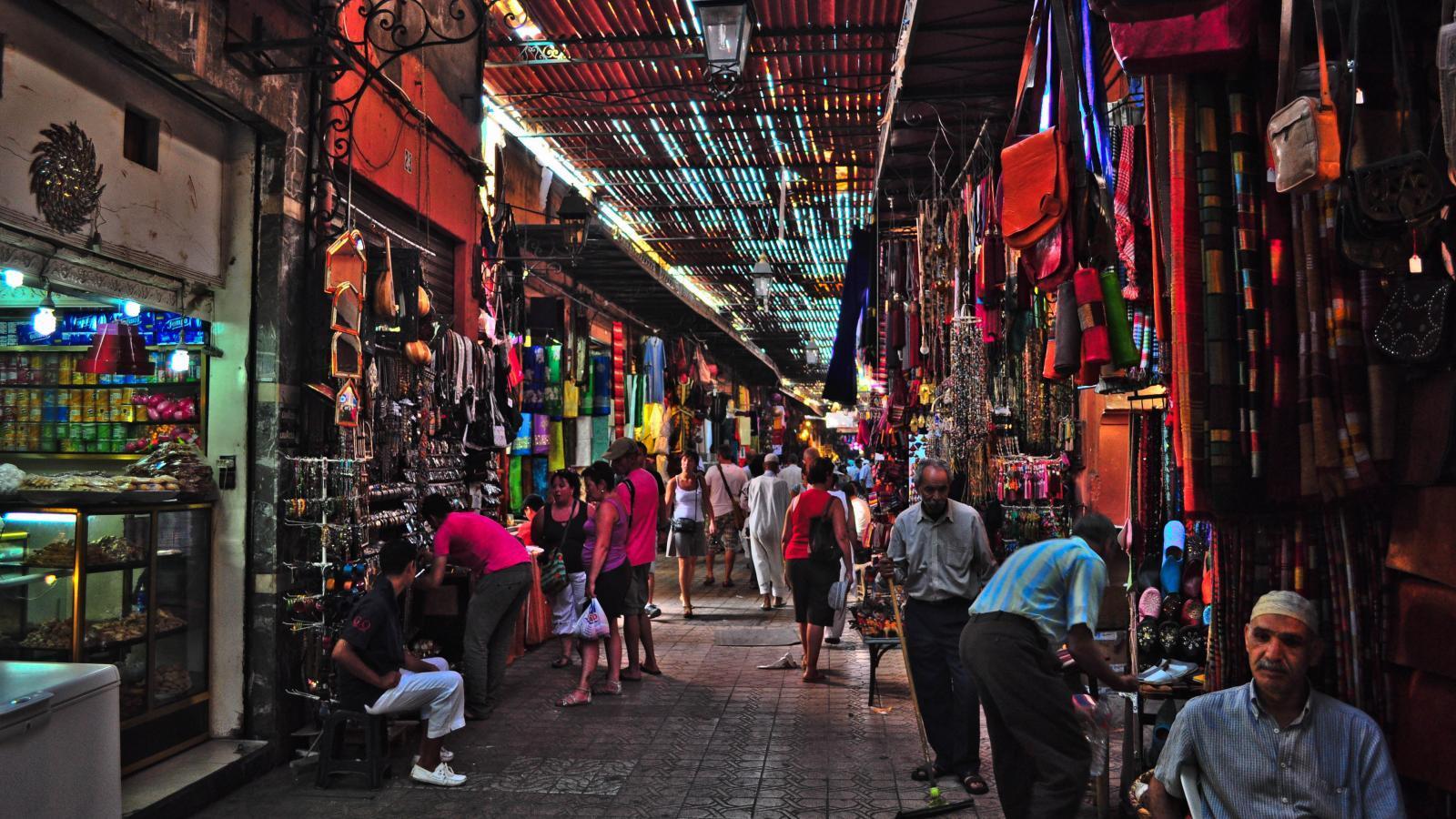 A small group of travelers exploring the vibrant streets of Marrakech with O.A.T. Travel.