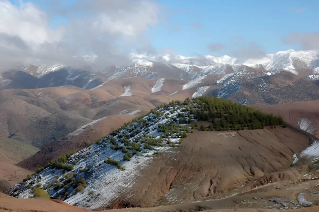Things to Do in Morocco A scenic view of the rugged peaks and lush valleys of the Atlas Mountains in Morocco.