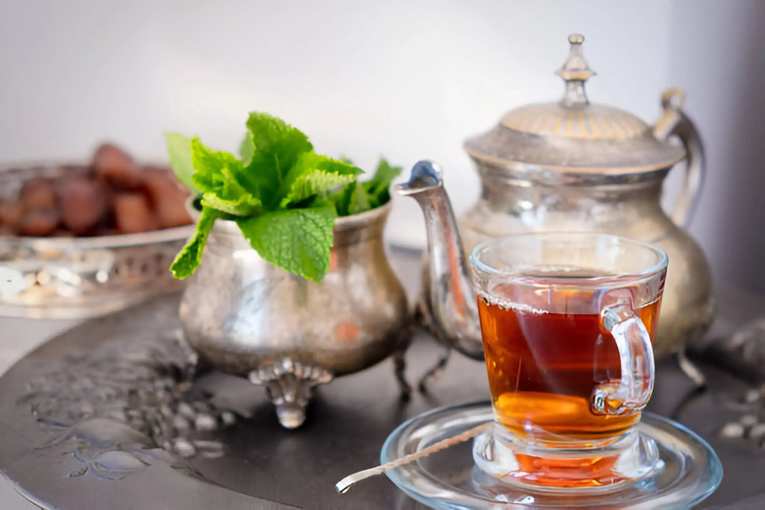 Moroccan mint tea in traditional teapot and glasses.