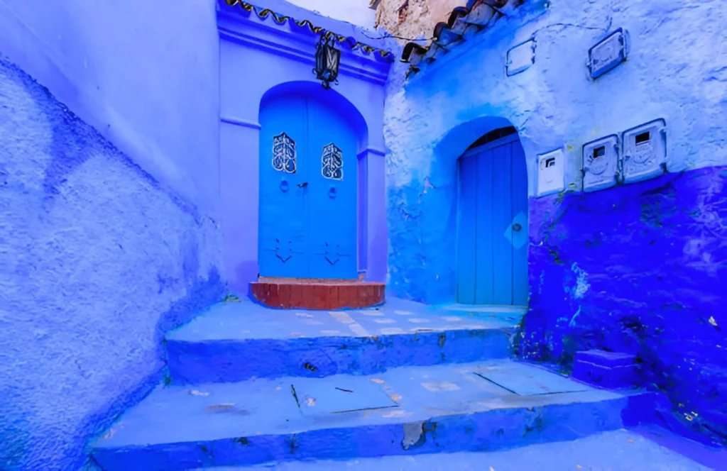 Blue City Best Cities to Visit in Morocco. The blue-washed streets of Chefchaouen, Morocco, with traditional Moroccan architecture and mountain backdrop.
